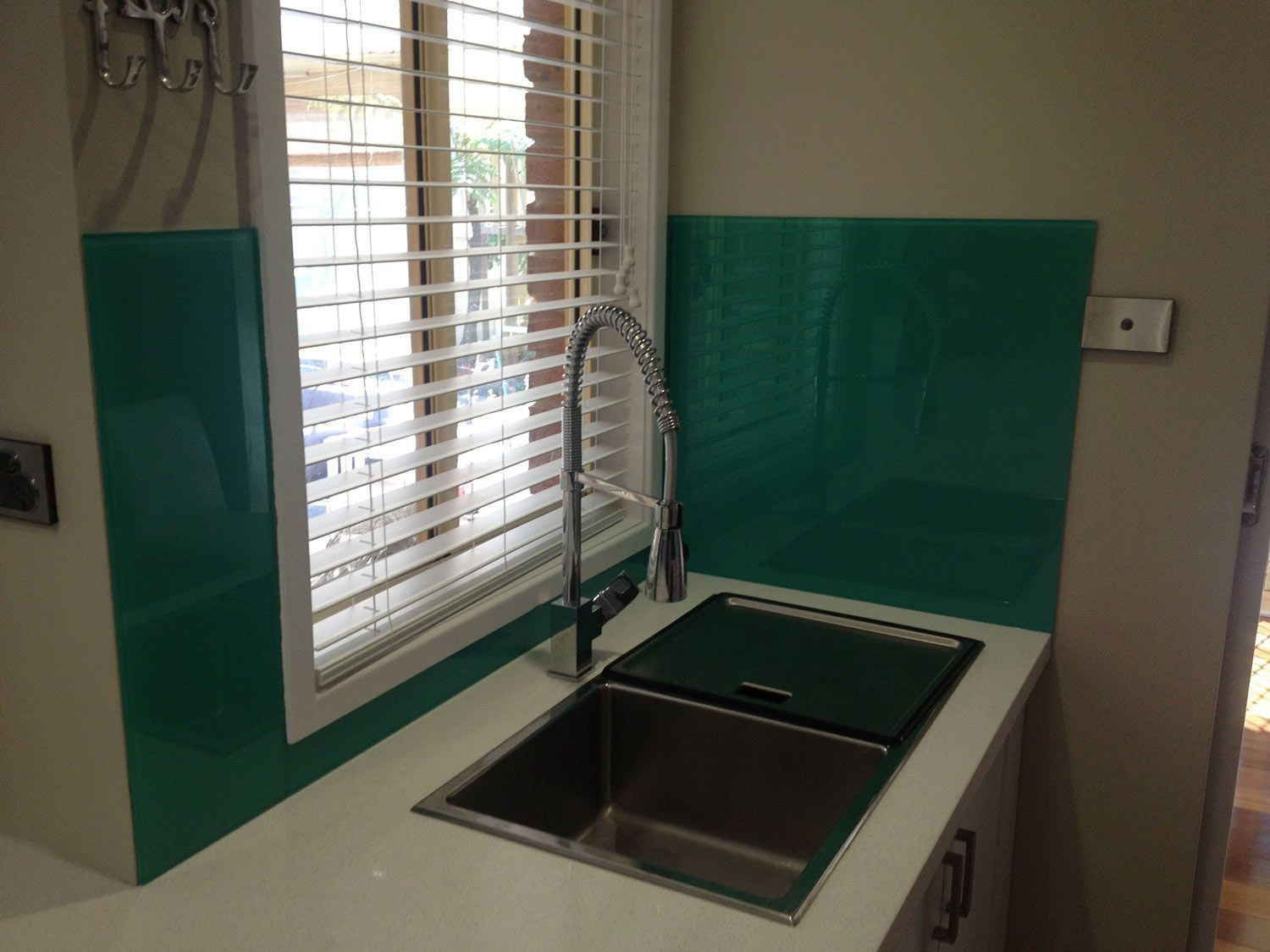 A Kitchen with a Teal Color Wall Splashback — Glass Windows & Doors in Shoalhaven, NSW