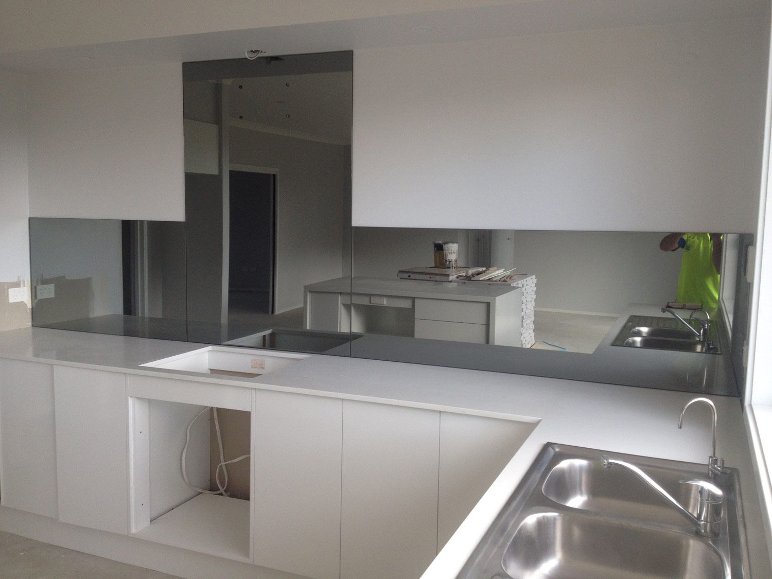 A Kitchen with a Mirror Wall Splashback — Glass Windows & Doors in Shoalhaven, NSW