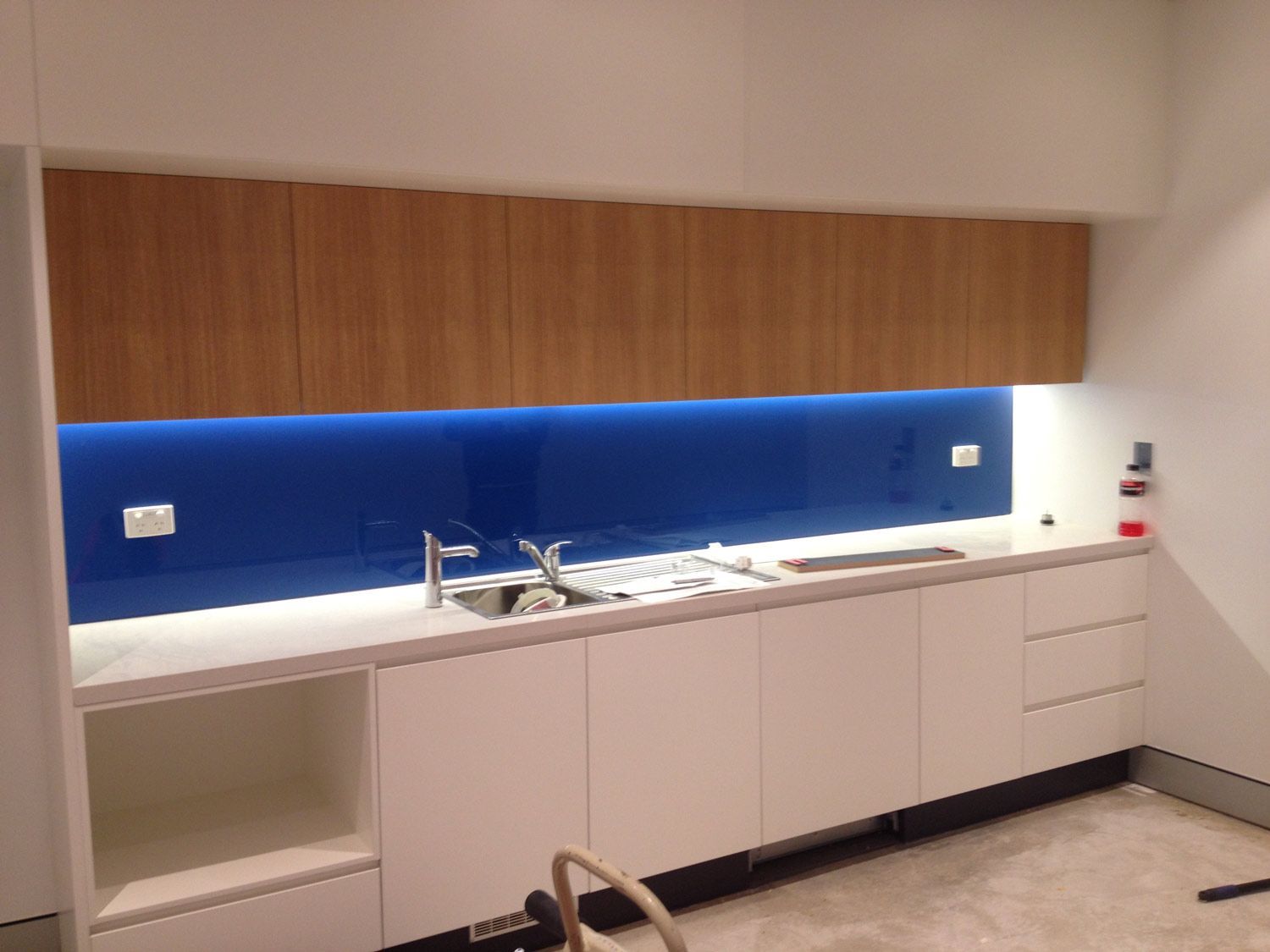 A Kitchen with Blue Wall and Splashback — Glass Windows & Doors in Shoalhaven, NSW