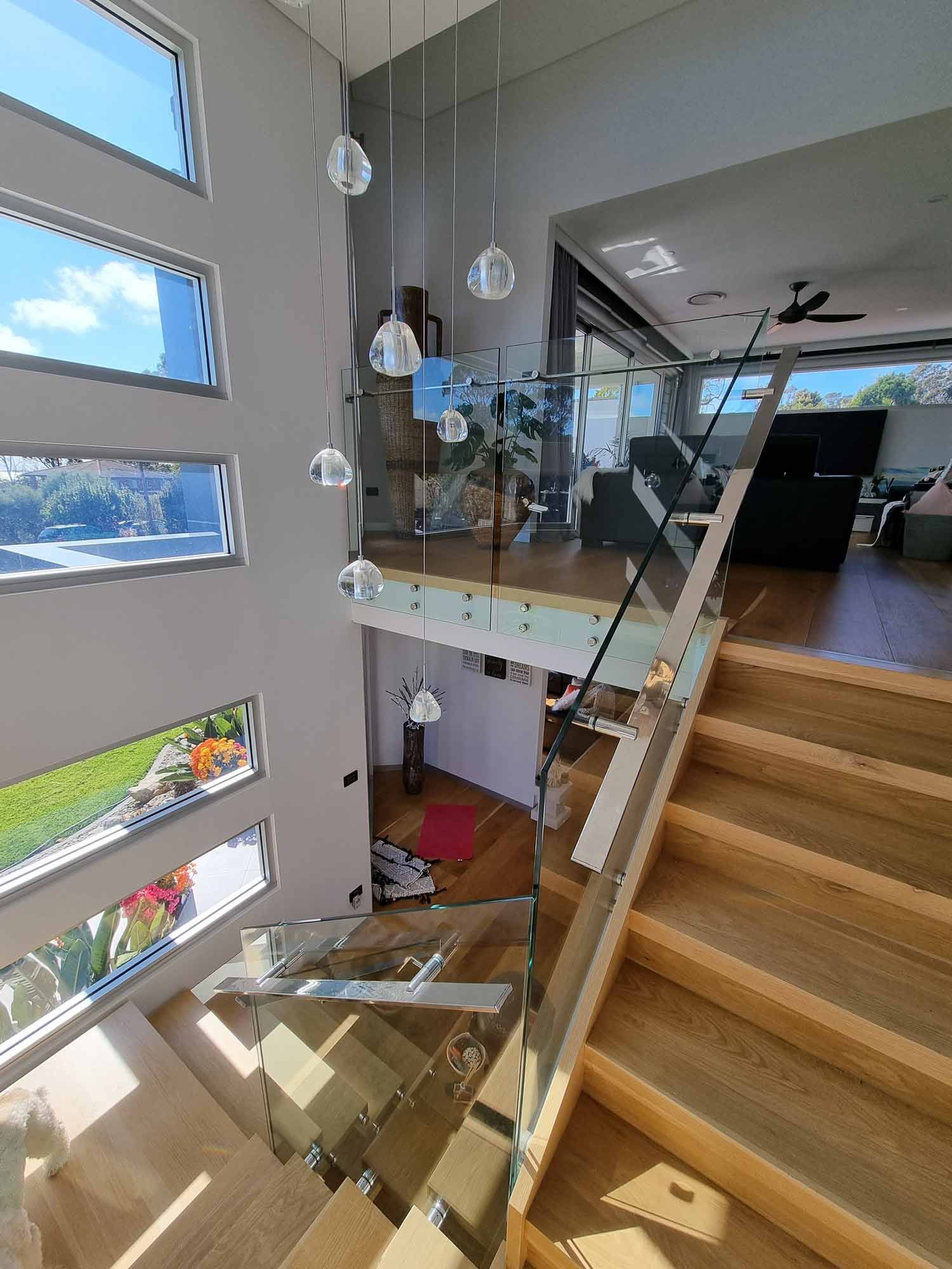 A House with Stairs and Chandelier — Glass Windows & Doors in Shoalhaven, NSW