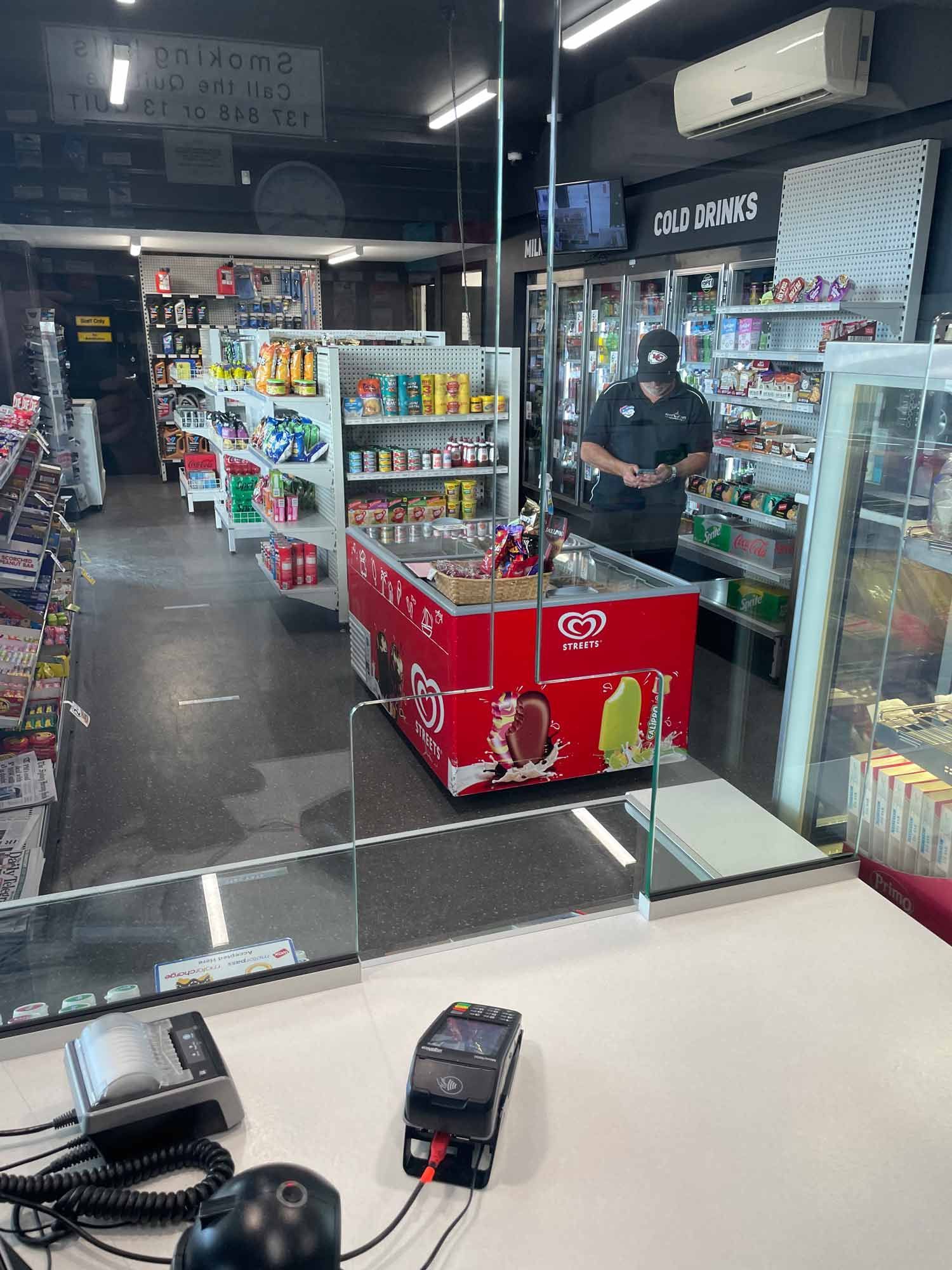 A Counter with a Nicely Cut Glass Partition — Glass Windows & Doors in Shoalhaven, NSW