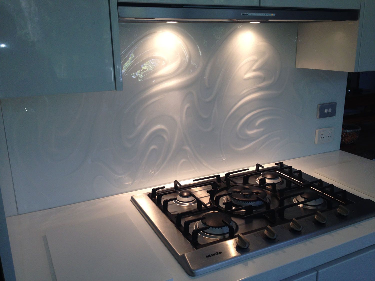 A Kitchen with a White Splashback with Engraved Design and Lights — Glass Windows & Doors in Shoalhaven, NSW