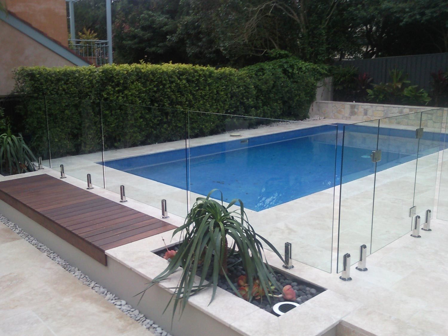 A Clean and Modern Pool with Fencing and Wood Deck — Glass Windows & Doors in Shoalhaven, NSW