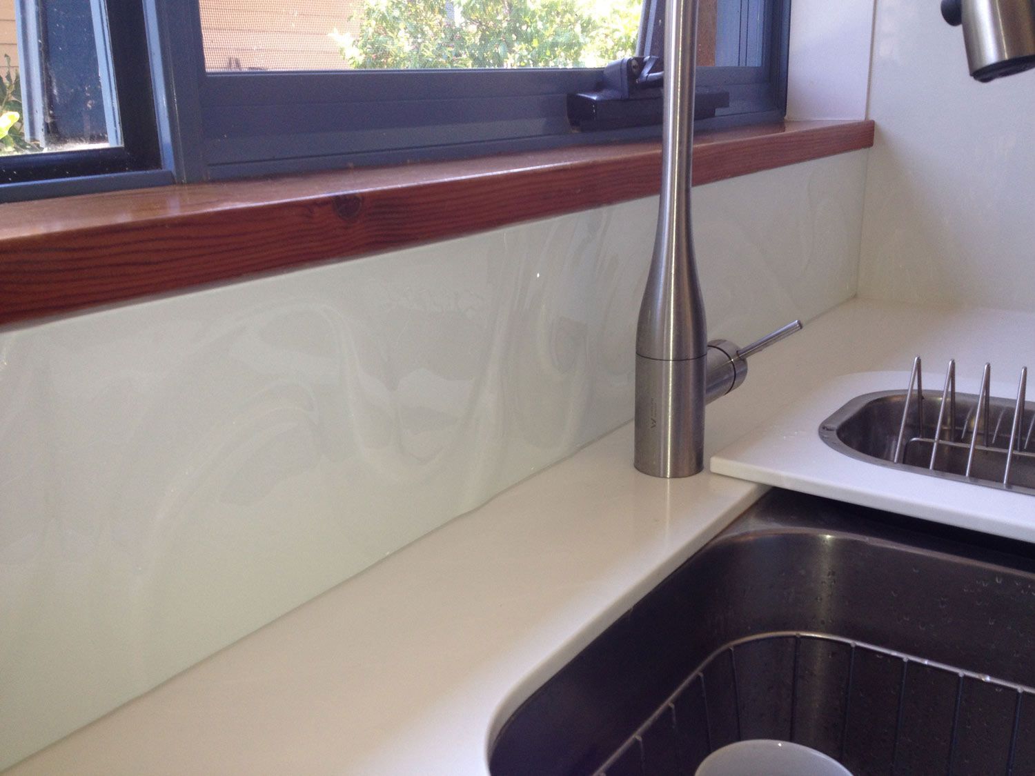 A Kitchen with a White Splashback — Glass Windows & Doors in Shoalhaven, NSW