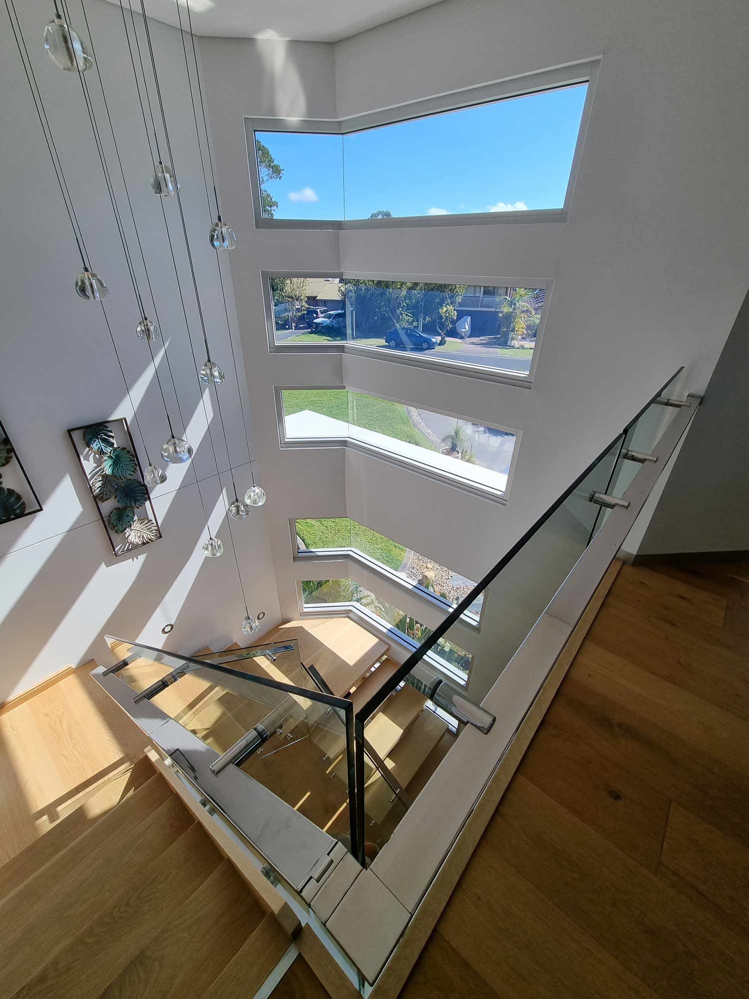 A Top View of Staircase Connected with the Glass — Glass Windows & Doors in Shoalhaven, NSW