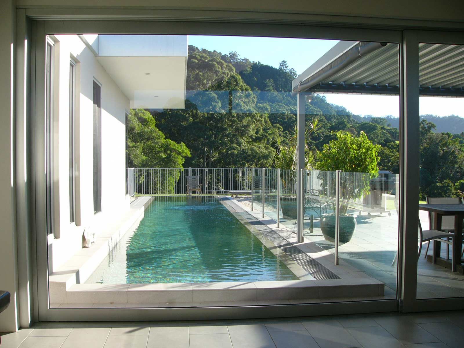 A Long Pool Surrounding with Glass Balustrades — Glass Windows & Doors in Shoalhaven, NSW