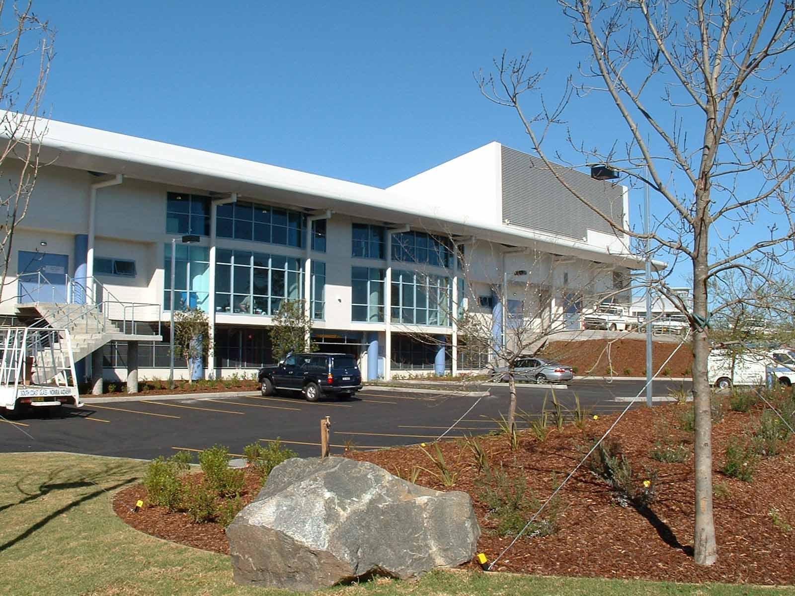 A Building with Blue Tinted Windows — Glass Windows & Doors in Shoalhaven, NSW