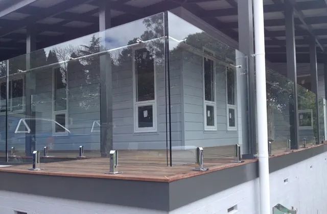 Grey House with Glass Balustrades in Patio — South Coast Glass in Shoalhaven, NSW