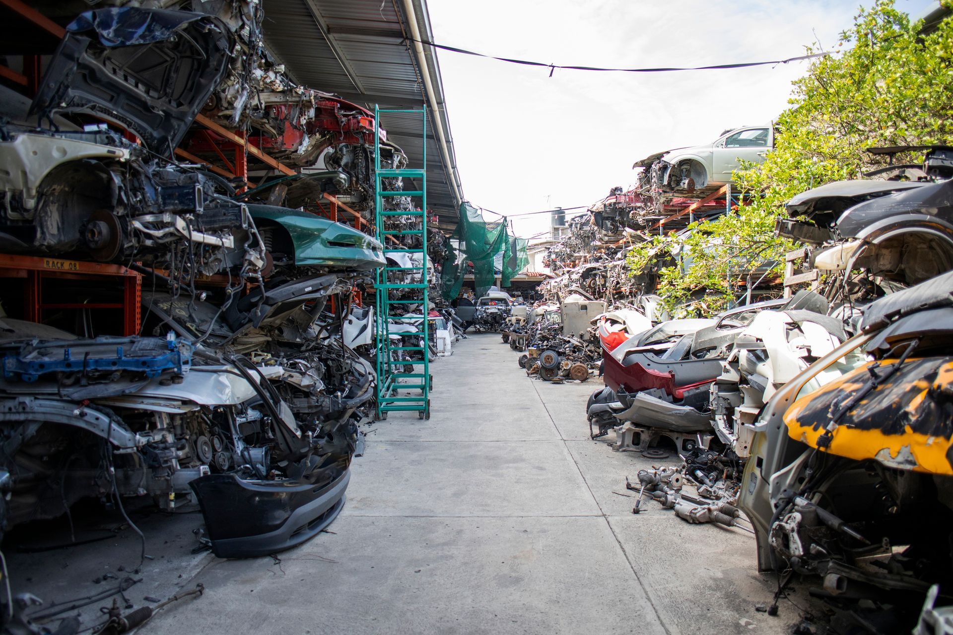 Cars are stacked on top of each other in a junkyard.