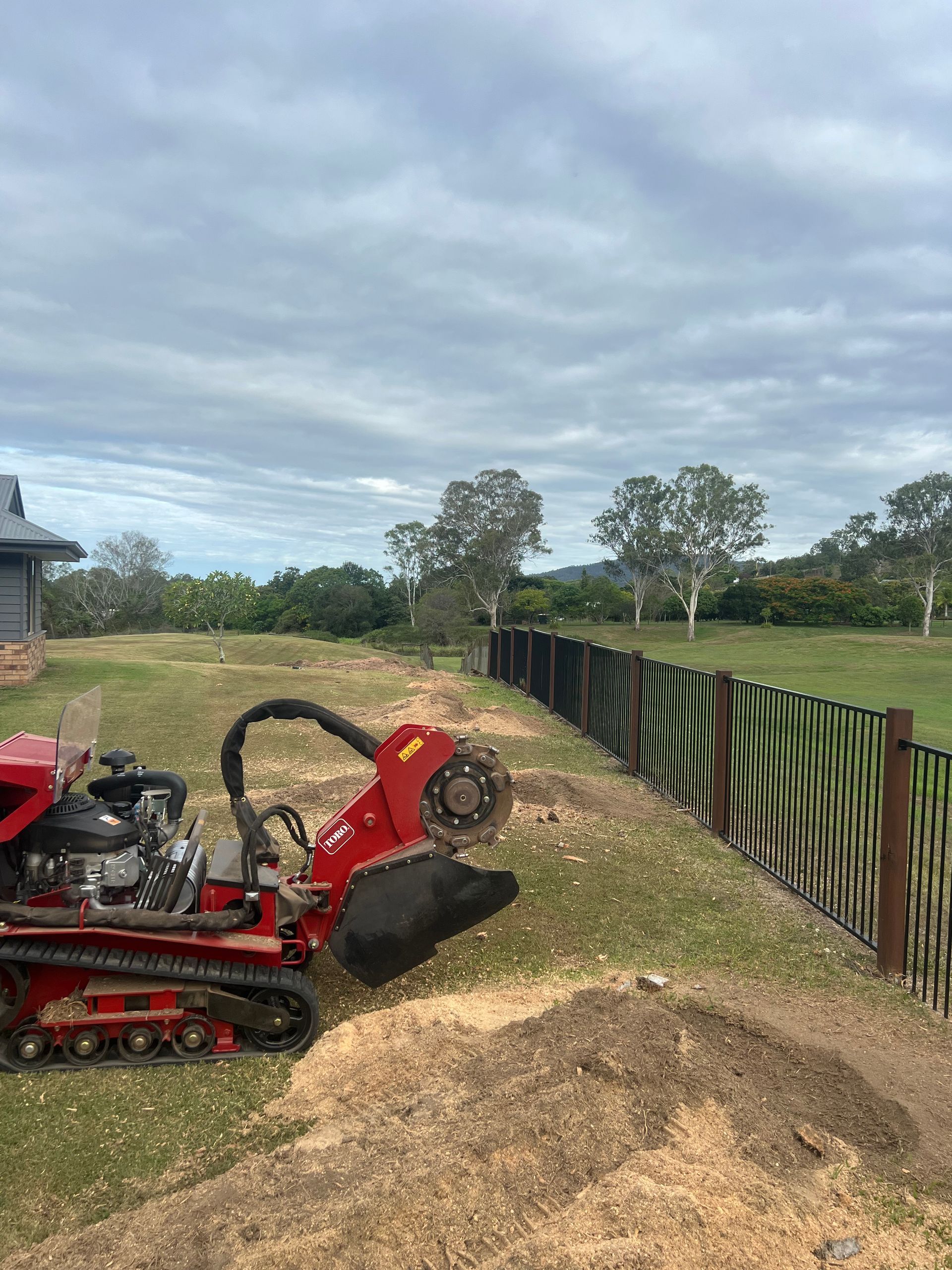 Removing stumps along a fence line.