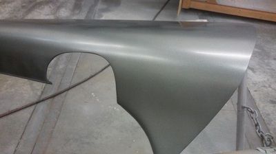 A close up of a metal fender on a concrete floor
