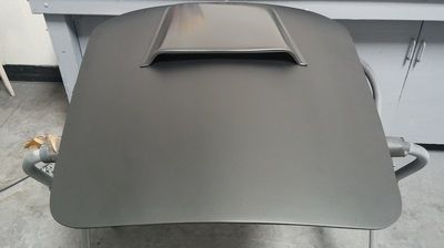 A gray table with a hood on top of it