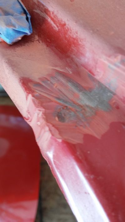 A close up of a person 's arm with red paint on it