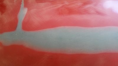 A close up of a red and blue painting on a wall