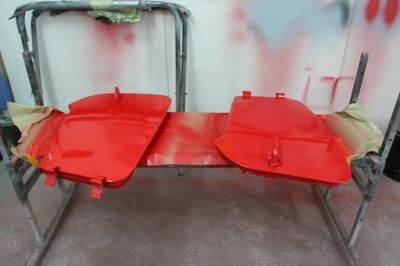 Two red pieces of metal are sitting on top of a table