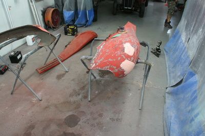 A red object is sitting on a stand in a garage