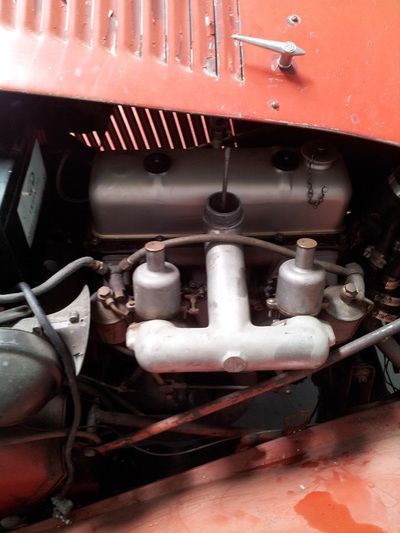 A close up of the engine of an old car