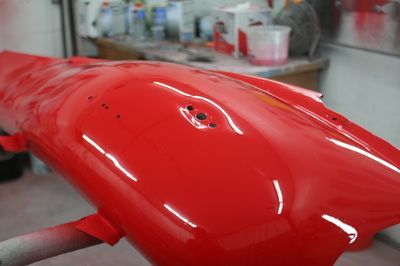 A red object is sitting on a table in a garage