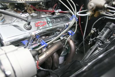 A close up of a chevrolet engine with a lot of wires coming out of it