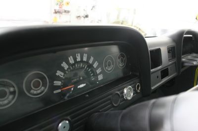 A close up of a car dashboard with a speedometer