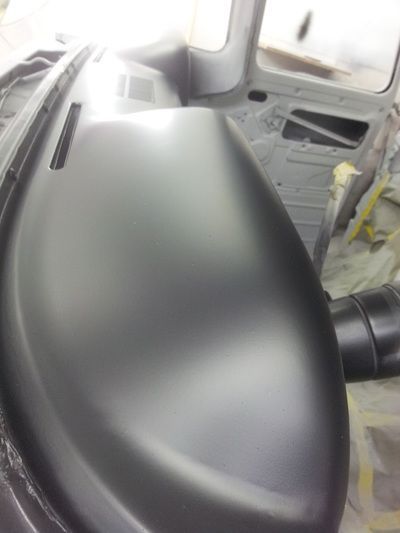 The dashboard of a car is being painted black