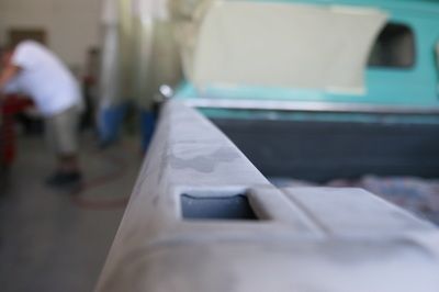 A person is working on a car in a garage