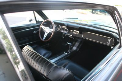 The inside of a car with a steering wheel and seats