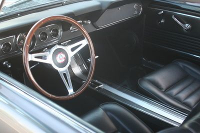 A car with a wooden steering wheel and black seats