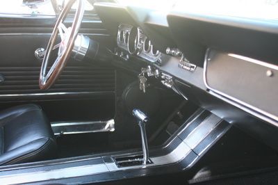 A close up of a car dashboard with a steering wheel