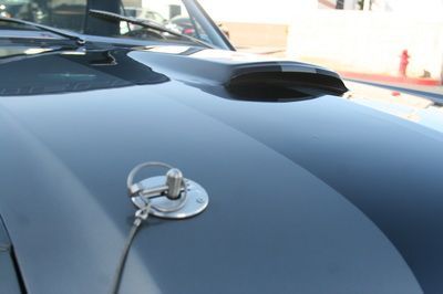 A close up of a car hood with a key on it
