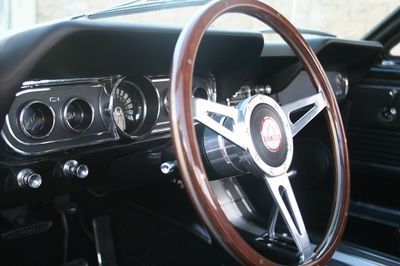 A close up of a steering wheel in a car