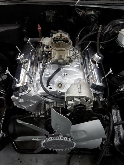 A close up of a car engine with a fan