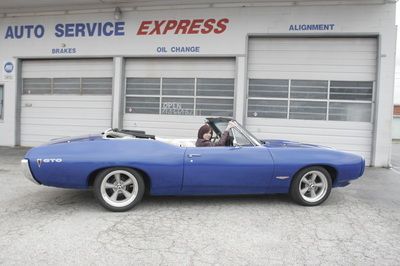 A blue car is parked in front of an auto service express