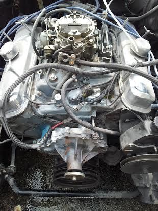 A close up of a car engine with a lot of wires coming out of it