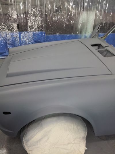 A car is sitting on top of a white pillow on a table