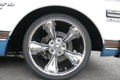 A close up of a car wheel with a chrome rim