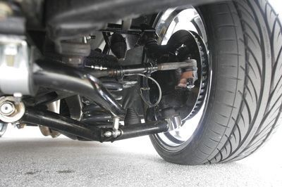 A close up of a car 's suspension and tire