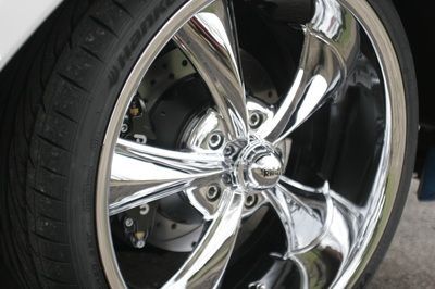 A close up of a car wheel with a tire on it