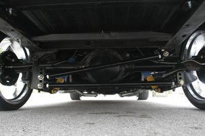 A close up of the underside of a truck 's suspension system