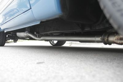 A blue car is parked on the side of the road