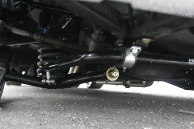 A close up of the underside of a car on the road