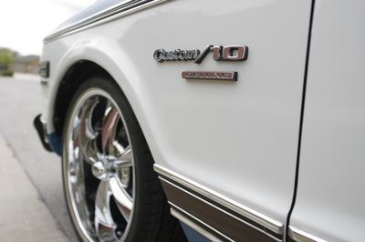 A close up of a white car with chrome wheels