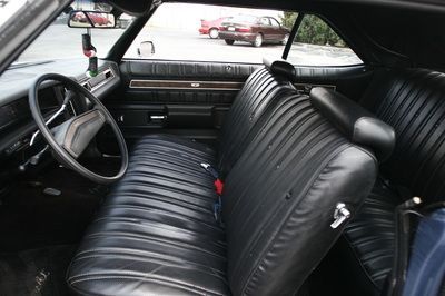 The inside of a car with black leather seats and a steering wheel