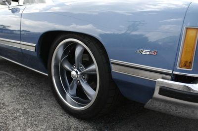 A blue car with a 5.0 emblem on the side