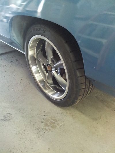 A close up of a car wheel with a tire on it