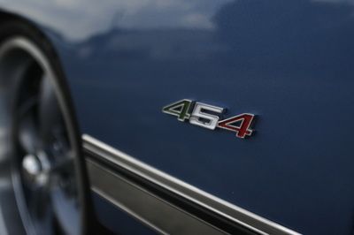 The emblem on the side of a blue car says 454