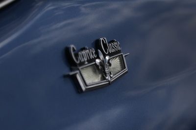 A close up of the emblem on the back of a blue car