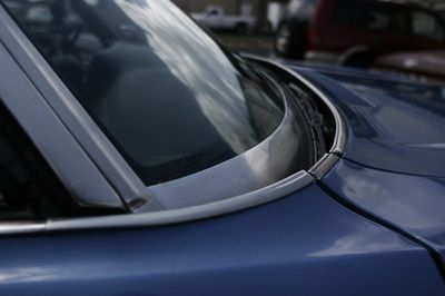 A close up of the windshield of a blue car