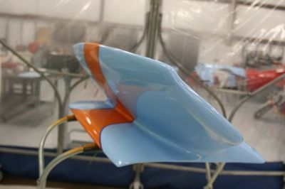 A blue and orange chair with a hose attached to it