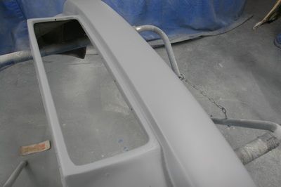 A car bumper is being painted